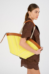 Profile view of model wearing the Oroton Callaway Tote in Amber/Daisy and Canvas for Women