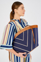 Profile view of model wearing the Oroton Callaway Tote in Fisherman Blue/Amber and Canvas for Women