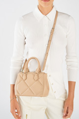 Profile view of model wearing the Oroton Inez Quilted Mini City Tote in Praline and Smooth Leather for Women