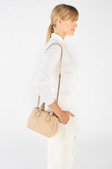 Profile view of model wearing the Oroton Inez Quilted Mini City Tote in Praline and Smooth Leather for Women