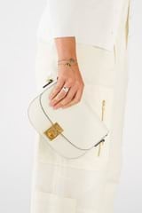 Profile view of model wearing the Oroton Yvonne Small Saddle Bag in Cream and Pebble Leather for Women