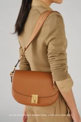 Profile view of model wearing the Oroton Yvonne Medium Day Bag in Tan and Pebble Leather for Women
