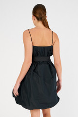 Profile view of model wearing the Oroton Taffeta Mini Dress in Black and 100% polyester for Women