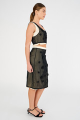 Profile view of model wearing the Oroton Mini 3D Flower Overlay Skirt in Black/Cream and Underlay: 80% acetate, 20% polyester. Overlay: 100% cotton for Women