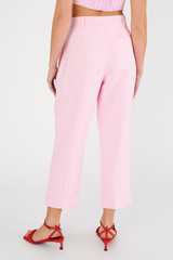 Profile view of model wearing the Oroton Pleat Pant in Rose and 58% viscose, 42% linen for Women
