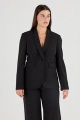 Profile view of model wearing the Oroton Black Fitted Blazer in Black and 53% Polyester 42% Wool 5% Elastane for Women