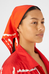 Profile view of model wearing the Oroton Daisy Scarf in Poppy and 100% silk for Women