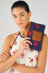 Profile view of model wearing the Oroton Boyd Printed Medium Pouch in Dutch Tulip Print and Canvas and leather trims for Women