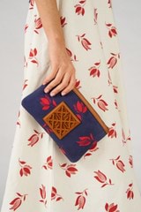 Profile view of model wearing the Oroton Boyd Printed Medium Pouch in Dutch Tulip Print and Canvas and leather trims for Women