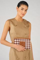 Profile view of model wearing the Oroton Boyd Printed Medium Pouch in Gingham and Canvas and leather trims for Women