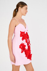 Profile view of model wearing the Oroton Contrast 3D Flower Mini Dress in Rose/Poppy and 100% linen for Women