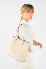 Profile view of model wearing the Oroton Polly Medium Zip Tote in Oatmeal and Pebble Leather for Women