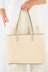 Profile view of model wearing the Oroton Polly Medium Zip Tote in Oatmeal and Pebble Leather for Women