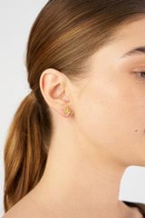 Profile view of model wearing the Oroton Daisy Studs in 18K Gold and Sustainably sourced 925 Sterling Silver for Women