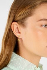 Profile view of model wearing the Oroton Daisy Drop Studs in 18K Gold and Sustainably sourced 925 Sterling Silver for Women