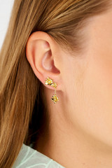 Profile view of model wearing the Oroton Daisy Drop Studs in 18K Gold and Recycled 925 Sterling Silver for Women