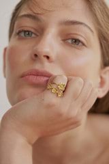 Profile view of model wearing the Oroton Daisy Ring Band in 18K Gold and Sustainably sourced 925 Sterling Silver for Women
