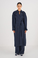 Profile view of model wearing the Oroton Trench Coat in North Sea and 58% Viscose 42% Linen for Women