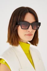 Profile view of model wearing the Oroton Stevie Sunglasses in Signature Tort and Bio acetate (Biodegradeable) for Women