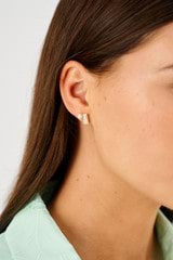 Profile view of model wearing the Oroton Calypso Pearl Stud in 18K Gold and Sustainably sourced 925 Sterling Silver for Women