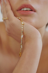 Profile view of model wearing the Oroton Calypso Tennis Bracelet in 18K Gold and Recycled 925 Sterling Silver for Women