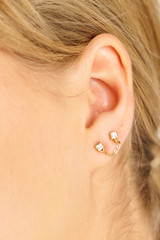 Profile view of model wearing the Oroton Everly Drop Studs in Gold/Clear and Brass for Women