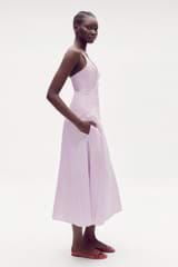 Profile view of model wearing the Oroton Poplin Sundress in Lilac and 100% cotton for Women