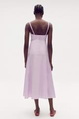 Profile view of model wearing the Oroton Poplin Sundress in Lilac and 100% cotton for Women