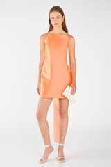 Profile view of model wearing the Oroton Drape Back Mini Dress in Bright Melon and 85% polyester, 15% silk for Women