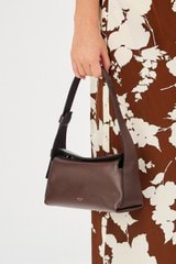 Profile view of model wearing the Oroton Caroline Small Day Bag in Bear Brown and Smooth leather for Women