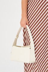 Profile view of model wearing the Oroton Caroline Hobo in Paper White and Smooth leather for Women