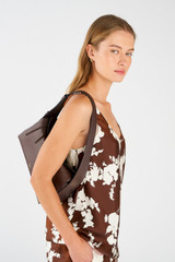 Profile view of model wearing the Oroton Caroline Hobo in Bear Brown and Smooth leather for Women