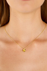 Profile view of model wearing the Oroton Daisy Pendant in 18K Gold and Sustainably sourced 925 Sterling Silver for Women