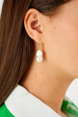 Profile view of model wearing the Oroton Marleigh Earrings in Gold and Baroque freshwater pearl for Women