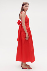 Profile view of model wearing the Oroton Tie Back Sundress in Poppy and 100% cotton for Women