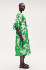 Profile view of model wearing the Oroton Silhouette Print Column Dress in Jewel Green and 100% silk for Women