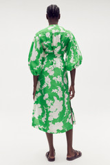 Profile view of model wearing the Oroton Silhouette Print Column Dress in Jewel Green and 100% silk for Women