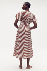 Profile view of model wearing the Oroton Sorrento Stripe Tie Dress in Deep Spice and 100% cotton for Women