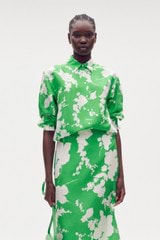 Profile view of model wearing the Oroton Silhouette Print Long Sleeve Shirt in Jewel Green and 100% silk for Women