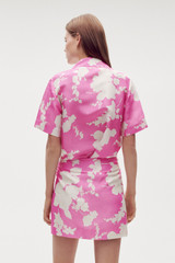 Profile view of model wearing the Oroton Silhouette Print Short Sleeve Camp Shirt in Carmine Pink and 100% silk for Women