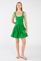 Profile view of model wearing the Oroton Short Tie Back Dress in Jewel Green and 100% cotton for Women