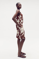 Profile view of model wearing the Oroton Silhouette Print Short in Deep Spice and 100% silk for Women