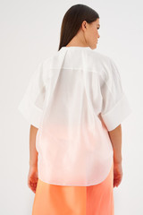 Profile view of model wearing the Oroton Short Sleeve Silk Dupion Overshirt in White and 100% silk for Women