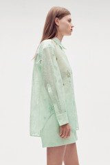 Profile view of model wearing the Oroton Lace Overshirt in Sea Spray and 100% polyester for Women