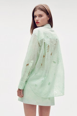 Profile view of model wearing the Oroton Lace Overshirt in Sea Spray and 100% polyester for Women