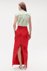Profile view of model wearing the Oroton Long Lace Skirt in Poppy and 100% polyester for Women