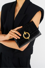 Profile view of model wearing the Oroton Alexa Texture Wallet Clutch in Black and Croc Effect Leather for Women