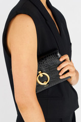 Profile view of model wearing the Oroton Alexa Texture Wallet Clutch in Black and Croc Effect Leather for Women
