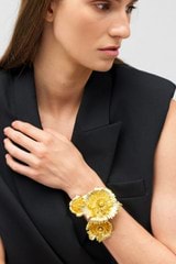 Profile view of model wearing the Oroton Etta Cuff in Worn Gold and Brass for Women