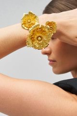 Profile view of model wearing the Oroton Etta Cuff in Worn Gold and Brass for Women